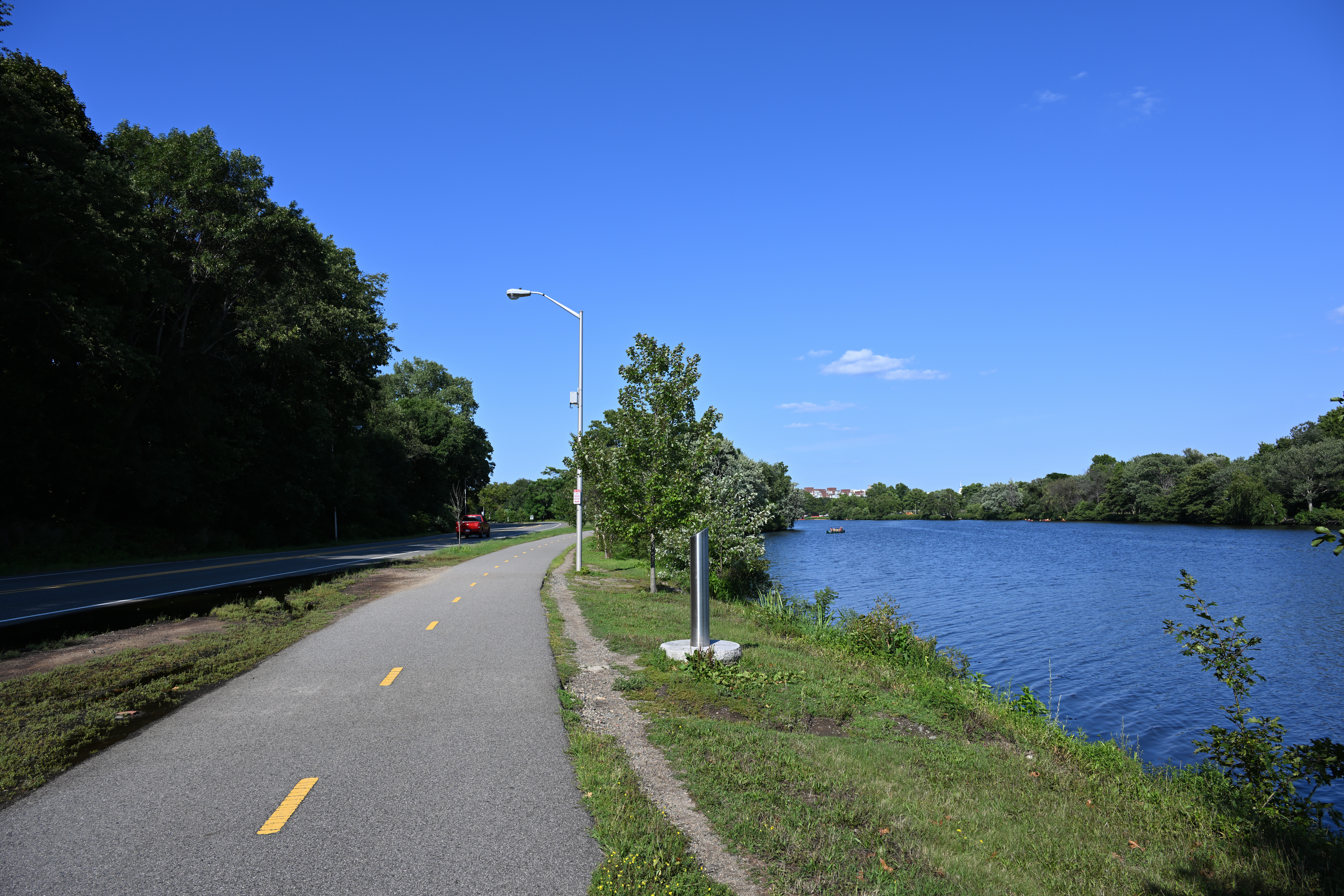 Family area at Magazine Beach with playground and HOCR boats visible on the Charles.